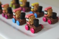 there are many pieces of chocolate that look like trains on the train tracks, and one is made out of candy