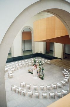 an empty wedding ceremony room with white chairs