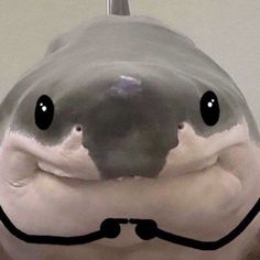 a close up of a stuffed animal with a smile on it's face and mouth