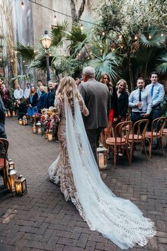 a bride and groom walking down the aisle