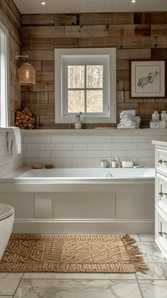 a bathroom with white fixtures and wood paneling on the walls, along with a large bathtub