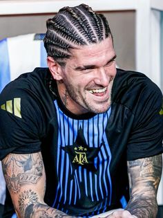 a man with dreadlocks on his hair sitting down