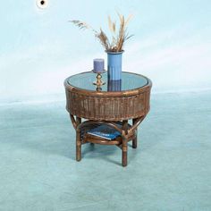 a wicker coffee table with two vases on top and a blue wall in the background