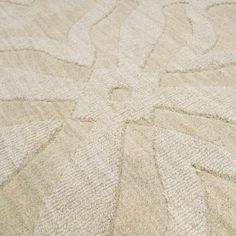 a white rug with an intricate design on the top and bottom part is shown in close up