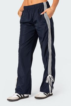 PRODUCT INFO Track pants Side stripe detailing Ribbon tie ankle detail Elastic waist Polyester Model wears size S Model height is 5'8 Item care: Wash with similar color Y2k Baggy, Visionary Fashion, Sweatpants Women, Casual Pants Style, Striped Sweatpants, Pants Details, Korean Clothing, Clothing Pants, Hip Hop Streetwear