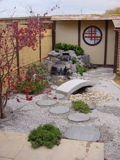 a japanese garden with rocks and plants