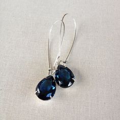 "Lightweight and easy to wear rhinestone earrings featuring sparkling Montana blue rhinestones, set in silver plated settings. Gorgeous shade of navy blue! These 14x10mm sparkling crystals dangle from silver plated, long style ear hooks. Also available in gold! The earrings are just over 2\" long. Thanks for stopping by!" Sterling Silver Teardrop Earrings With Sparkling Stones For Party, Sapphire Teardrop Crystal Earrings For Party, Teardrop Crystal Earrings With Rhinestones For Gift, Teardrop Crystal Earrings With Rhinestones, Teardrop Jewelry With Ear Wire For Bridesmaid Gift, Sterling Silver Teardrop Jewelry For Bridesmaid Gift, Earring Simple, Etsy Bridesmaid Gifts, Swarovski Crystal Earrings