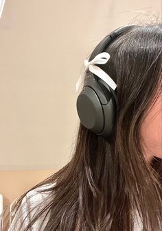 a woman with long hair wearing headphones