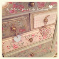 an old dresser is painted with floral designs and gold knobs on it's drawers