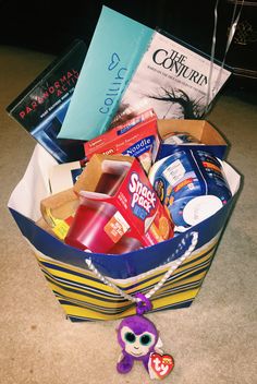 a basket filled with books and toys on the floor