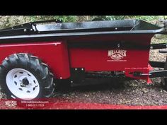 a red trailer with wheels on the ground