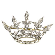 An antique diamond crown brooch, with Edwardian and old-cut diamonds, in grain and rub over settings, mounted in yellow gold with platinum settings, circa 1915, with a pin and roller catch fitting. Estimated total diamond weight 1.20 carats. Antique Crown, Diamond Crown Ring, Diamond Bows, Diamond Crown, Antique Brooches, Diamond Brooch, Heart Pendant Diamond, Gold Brooches, Gold Crown