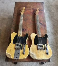 two guitars sitting on top of each other