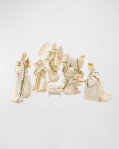 a group of figurines sitting on top of a white table next to each other