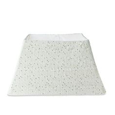 a white lamp shade with dots on it