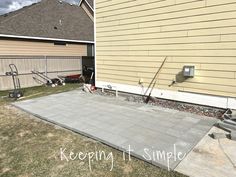 a concrete patio being built in front of a house with the words keeping it simple