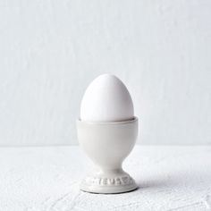 an egg sitting on top of a white bowl