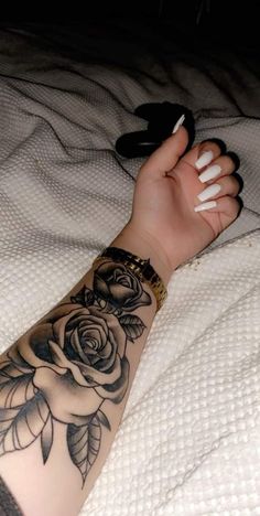 a woman's arm with a rose tattoo on it