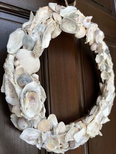 a wreath made out of seashells on a door