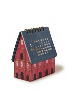 a small house shaped calendar sitting on top of a table