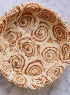 an uncooked pie sitting on top of a marble counter