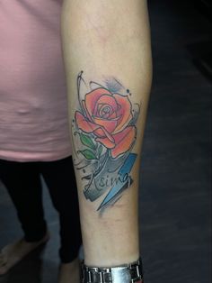 a woman with a rose tattoo on her arm