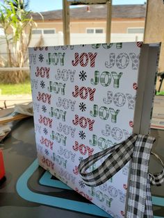 an open gift box sitting on top of a table covered in wrapping paper and ribbon