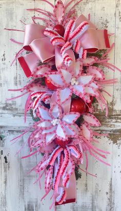 a pink and white wreath with candy canes