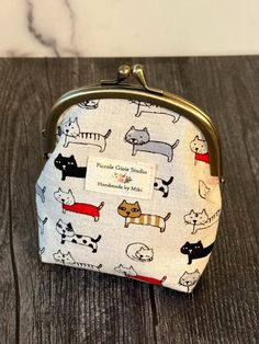 A small coin purse with many different cats; The outer fabric is canvas cotton which was imported from Japan. The inside layer is cotton with red on white polka dots. The metal part of the purse is silver color. The measurement is approximately 4" x 4.75". This cute coin purse is made by me with love. Hope you will love it!! Gamaguchi Purse, Cat Coin Purse, Fortune Cat, Lace Tape, Pouch Makeup, Image Swag, Towel Crafts, Spa Gifts Set, Maneki Neko