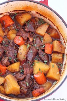 a pot filled with stew and vegetables on top of a table