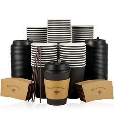 black and white coffee cups with chopsticks next to each other