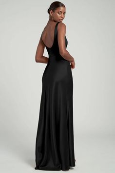 the back of a woman wearing a black evening gown