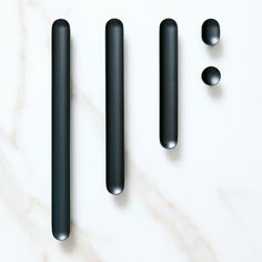 three black objects on a white surface