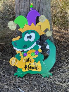 a wooden sign that says life of the mama with a dragon on it's head