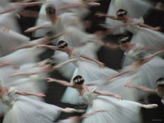 blurry photograph of dancers in white tutus