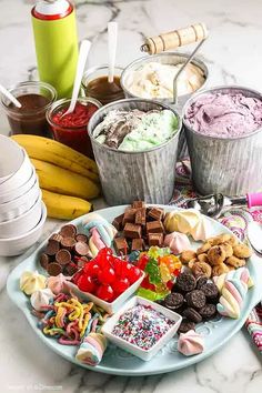 an assortment of ice creams and desserts are arranged on a marble countertop