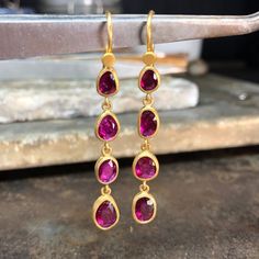 22K GOLD HANGING RUBY EARRINGS 5.15 CARAT • DESIGNED AND HAND FORGED IN NEW YORK Please email info@elihalili.com or call the studio at 212-941-7979 for any inquiries. Hand Forged Gold Ruby Jewelry, Gold Ruby Earrings Hand Set, Ruby Earrings, Emerald Jewelry, 22k Gold, Hand Forged, The Studio, Ruby, Emerald