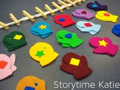 colorful felt shapes are arranged on a gray surface with clothes pins and clothes pegs