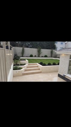 an outside view of a house with steps leading up to the front door and landscaping