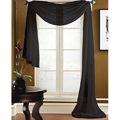 black sheer curtains in front of a window