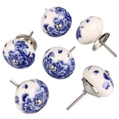 four blue and white knobs with flowers on them