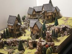 a model village with trees, rocks and houses