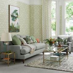 a living room with two couches and a coffee table in front of a window