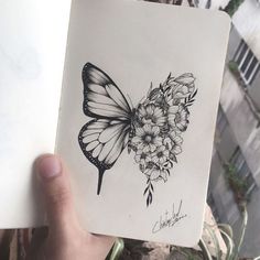 a drawing of a butterfly with flowers on it