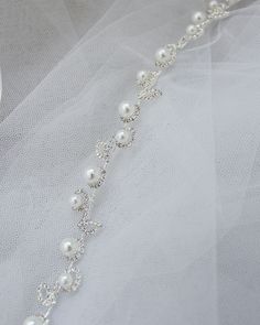 the bridal bracelet is adorned with pearls