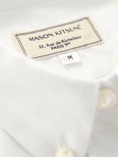 a white shirt with a label on it that says mason kitsune 52 rue deffilice paris