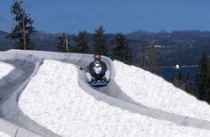 a man is sliding down a snow covered hill