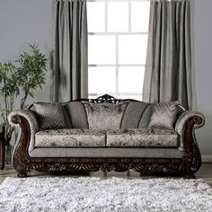 a living room filled with furniture and a white rug on top of a hard wood floor