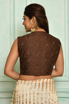 Brown chanderi padded blouse with thread, floral embroidery.
Component: 1
Pattern: Embroidery
Type Of Work: Thread, floral
Neckline: V neck
Sleeve Type: Sleeveless
Fabric: Chanderi, Lining: Cotton Silk
Color: Brown
Other Details: 
Note: Saree worn by the model is not for sale
Occasion: Puja - Aza Fashions Chikankari Embroidery Chanderi Blouse For Reception, Festive Chikankari Embroidery Art Silk Blouse, Sleeveless Traditional Wear With Resham Embroidery For Festive Occasions, Sleeveless Resham Embroidery Traditional Wear For Festive Occasions, Sleeveless Resham Embroidery Traditional Wear For Festive, Embroidered Sleeveless Tops For Navratri, Festive Sleeveless Traditional Wear With Resham Embroidery, Sleeveless Embroidered Traditional Wear For Festive Occasions, Festive Sleeveless Embroidered Traditional Wear