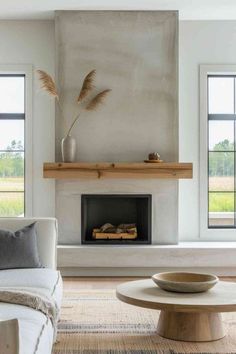 a living room with a couch, coffee table and fireplace